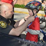 June 8, 2016 - 08:50 - 'Deputy Sheriff Brian Grazidei adjusts a child's bike helmet prior to a Suffolk County Sheriff's Office Bike Rodeo in Bayport, NY.


The Suffolk County Sheriff’s Office offers a Bike Rodeo and Safety Clinic to teach kids the real world skills they need to ride a bicycle safely. Lessons such as where to ride on the road, how to hand signal, how to safely cross an intersection, and how to properly wear a bicycle helmet are demonstrated and discussed by Sheriff’s Officers.'
Credit: Bryan Stoothoff, Suffolk County Sheriff's Office