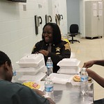 February 18, 2016 - 12:05 - The number of juvenile inmates in the Marion County Jail usually hovers around 40, but the command staff of the Jail understands that this population of inmates are still developing mentally and still need the care and attention of adults. Jail Commander James Martin and Major Tanesha Crear ordered a special lunch of cheeseburgers and chips in early 2016, and sat down with the juveniles to listen to what they have to say, and to also inform them of some upcoming programs based on good behavior. This photo of Major Tanesha Crear laughing with these young inmates really captures the heart of our Sheriff's Deputies in the Jail Division.
Credit: Katie Carlson, Marion County Sheriff's Office
